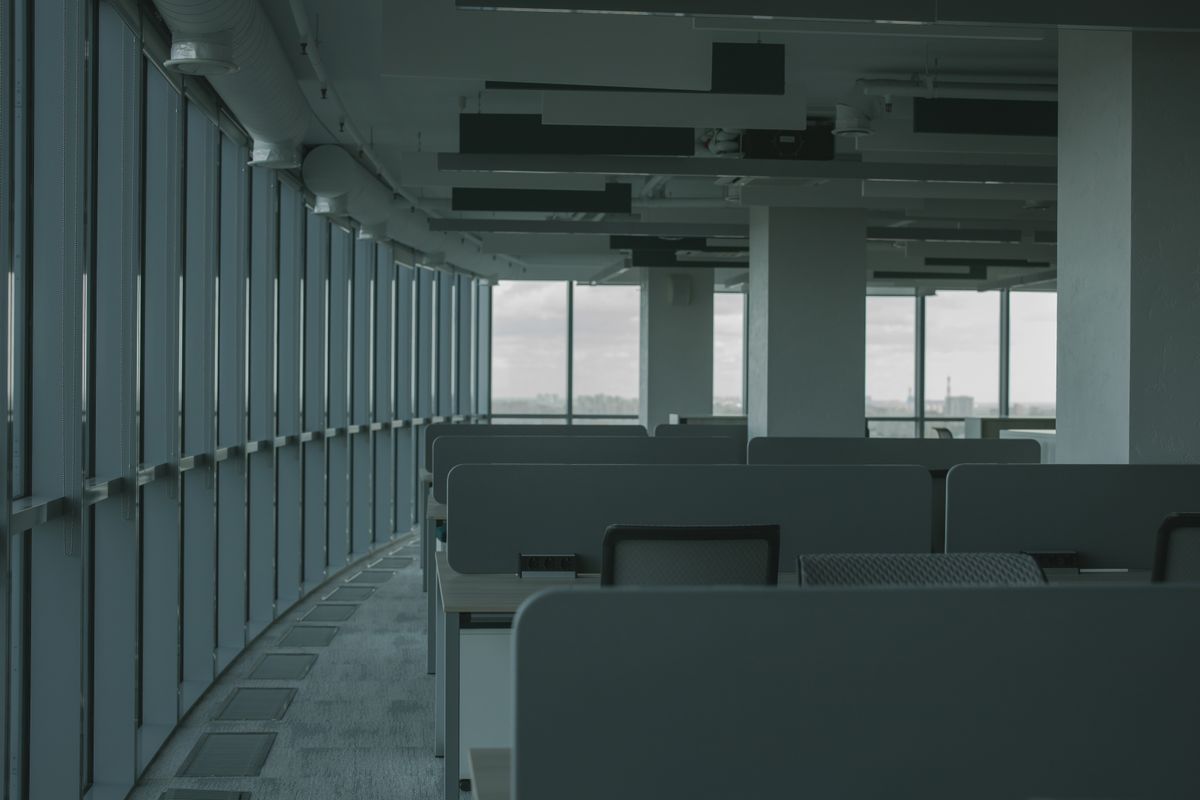 An empty company office with stacked chairs and lowered blinds, symbolising the summer closure of a business employing apprentices